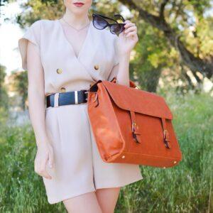 woman in brown dress with brown leather sling bag